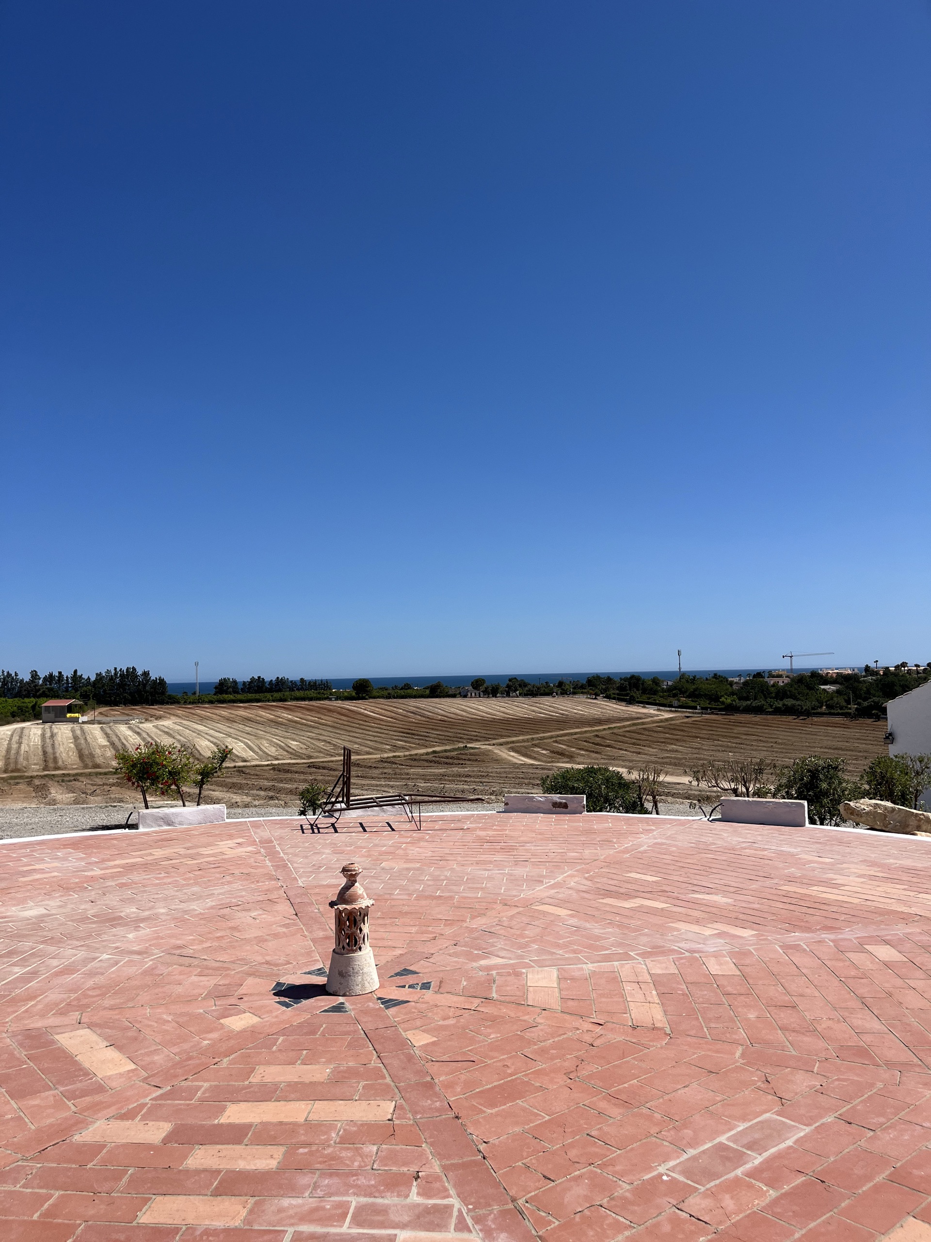 the farm's threshing floor with a sea view