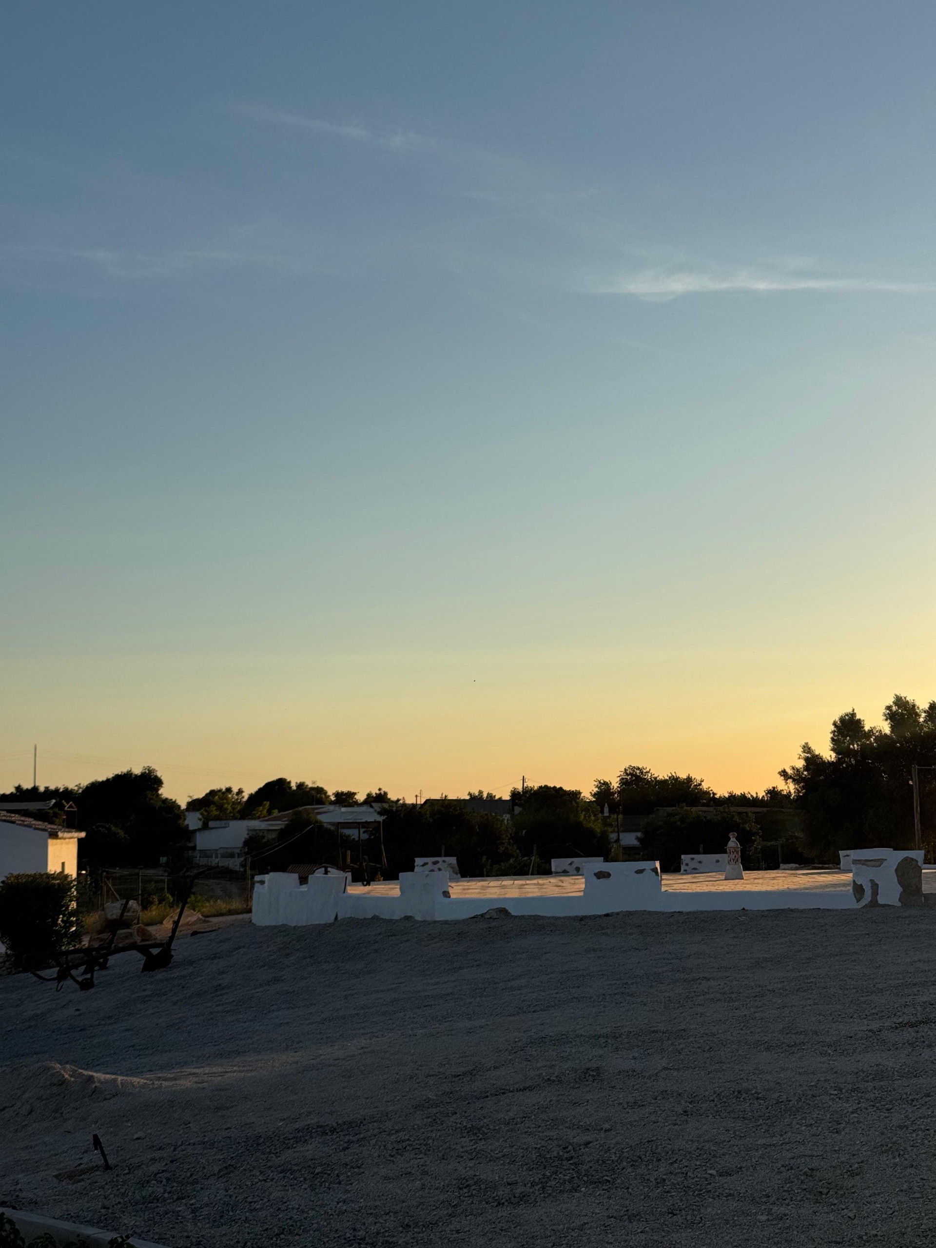 the farm's threshing floor at dusk